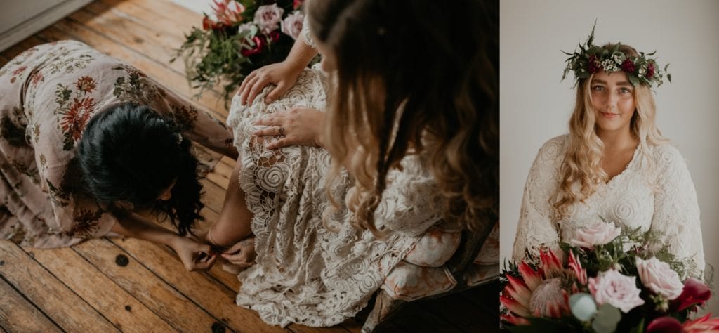 Collage of two images. Image on the right, a bridesmaid is helping the bride fasten the buckle on her shoes. The bride is wearing a lace gown. The image on the left, the bride is smiling at the camera and holding a large boho bouquet and wearing a matching flower crown. Images captured at The Clearing Wedding venue in Shedden, ON by Ashlee Ellison.