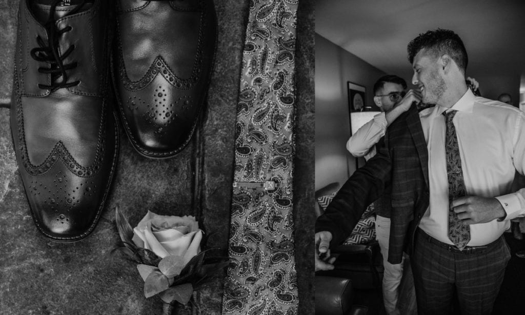 Black and white collage of two images. Image on left is a close up of the groom's shoes and boutonniere. Image on right is of a groomsmen helping the groom put his jacket on. Captured at The Clearing in Shedden, ON.