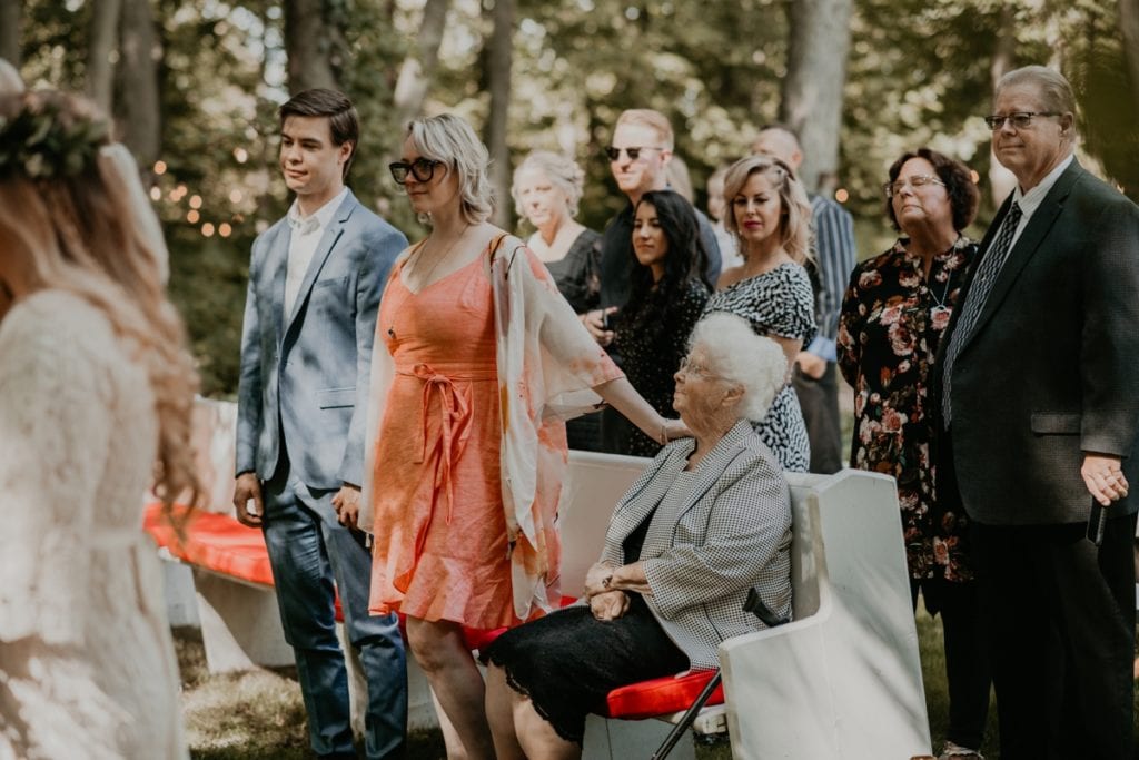 Guests stand for the bride's ceremony entrance at The Clearing in Shedden, ON.