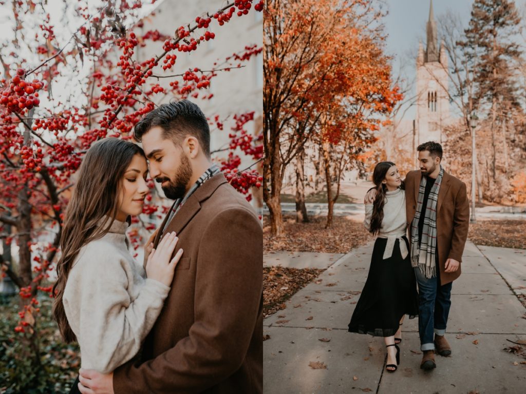 Man and woman walk along the pathways at UWO in London Ontario for their engagement photoshoot. the pathway is flanked by trees with fall foliage and in the distance you can see the clocktower. The man's arm is around the woman's neck and she is reaching up to clasp his hand. They are looking at each other smiling for an candid and intimate photo. Captured by top london ontario wedding and engagement photographer ashlee ellison.