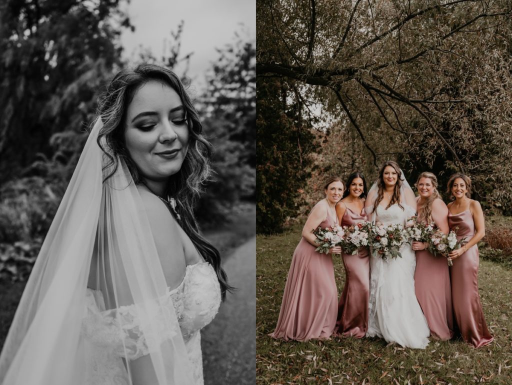 Bride and her four bridesmaids, wearing dusty rose, stand in front of a willow tree on the grounds of the Luso Valley Estate Farm for a wedding day portrait. All of the girls are looking at the camera and smiling.