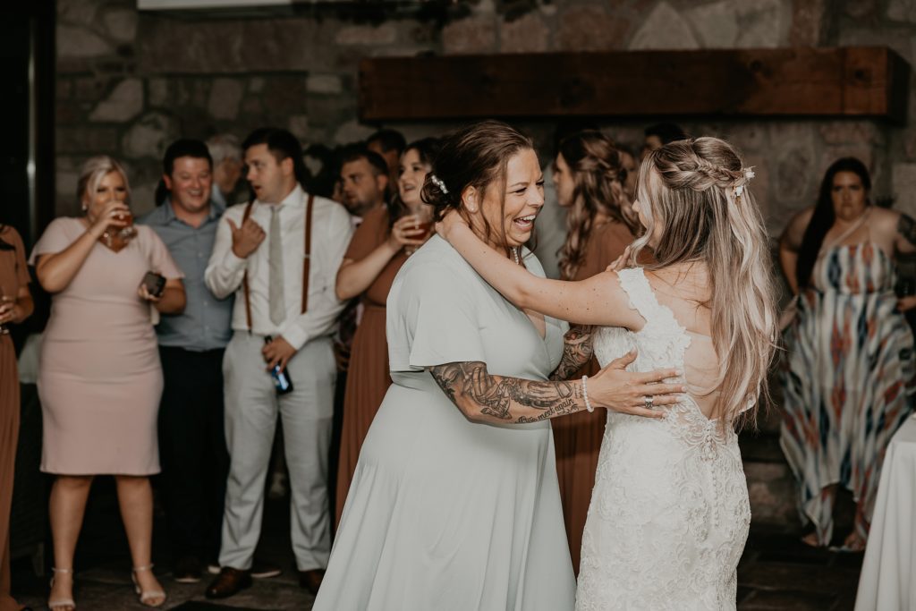 Bride and her mother share a fun dance at her Cambridge Mill wedding reception.