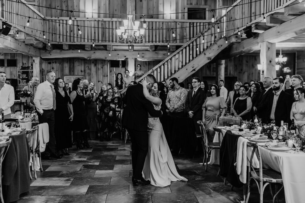 Bride and groom share their first dance at holland marsh wineries as their wedding guests stand around them. captured by top newmarket wedding photographer ashlee ellison.