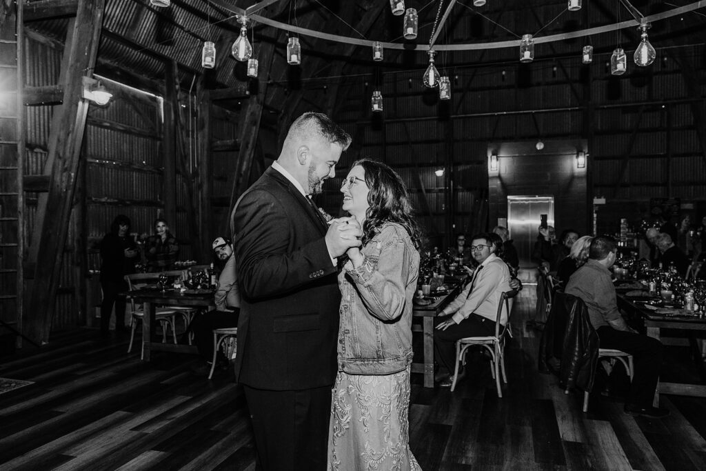 Black and white image of bride and groom sharing their first dance at their crescent hill acres wedding reception.